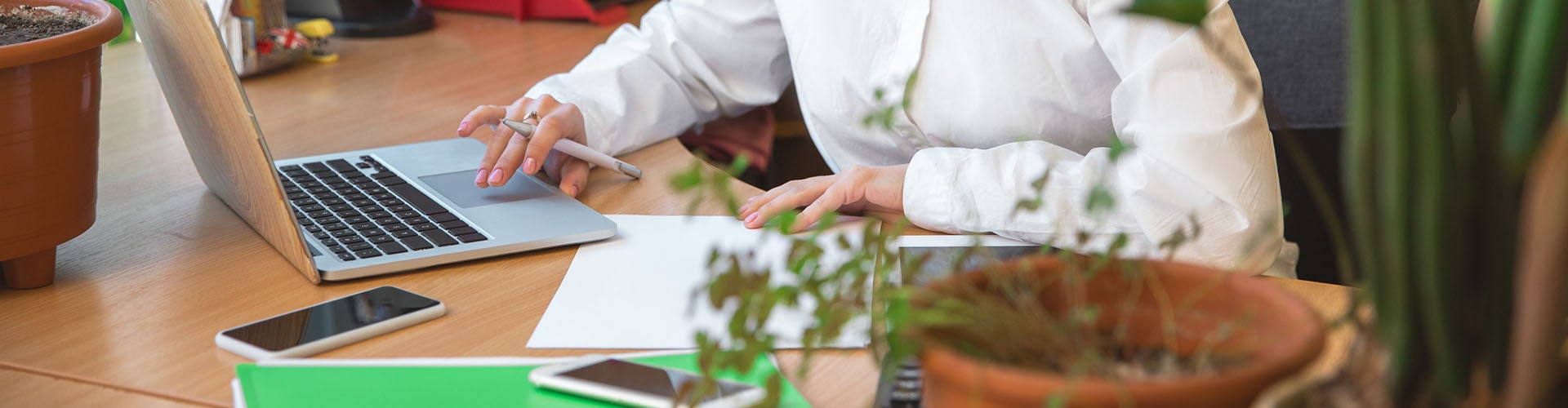 A person sitting at a desk with a laptop, working on business for sale.