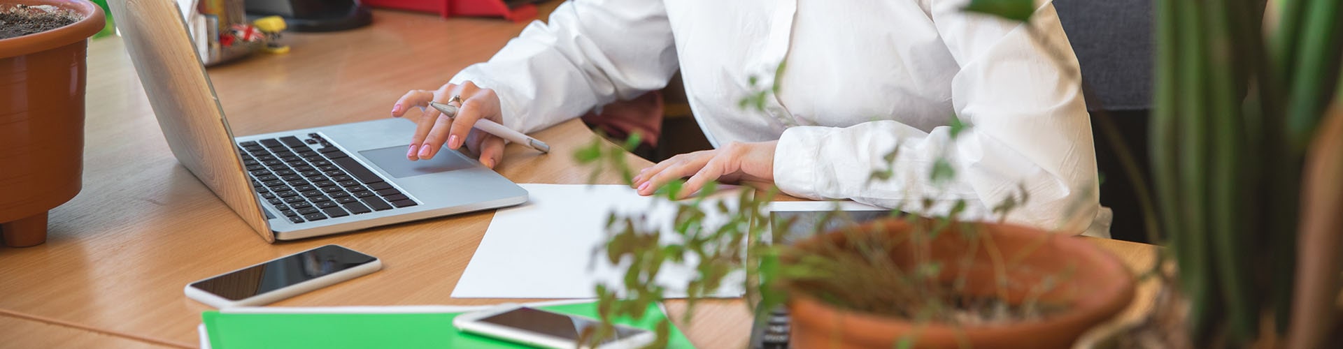 A person sitting at a desk with a laptop, working on business for sale.