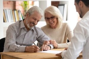 Man and woman completing paperwork for a business sale in Calgary.