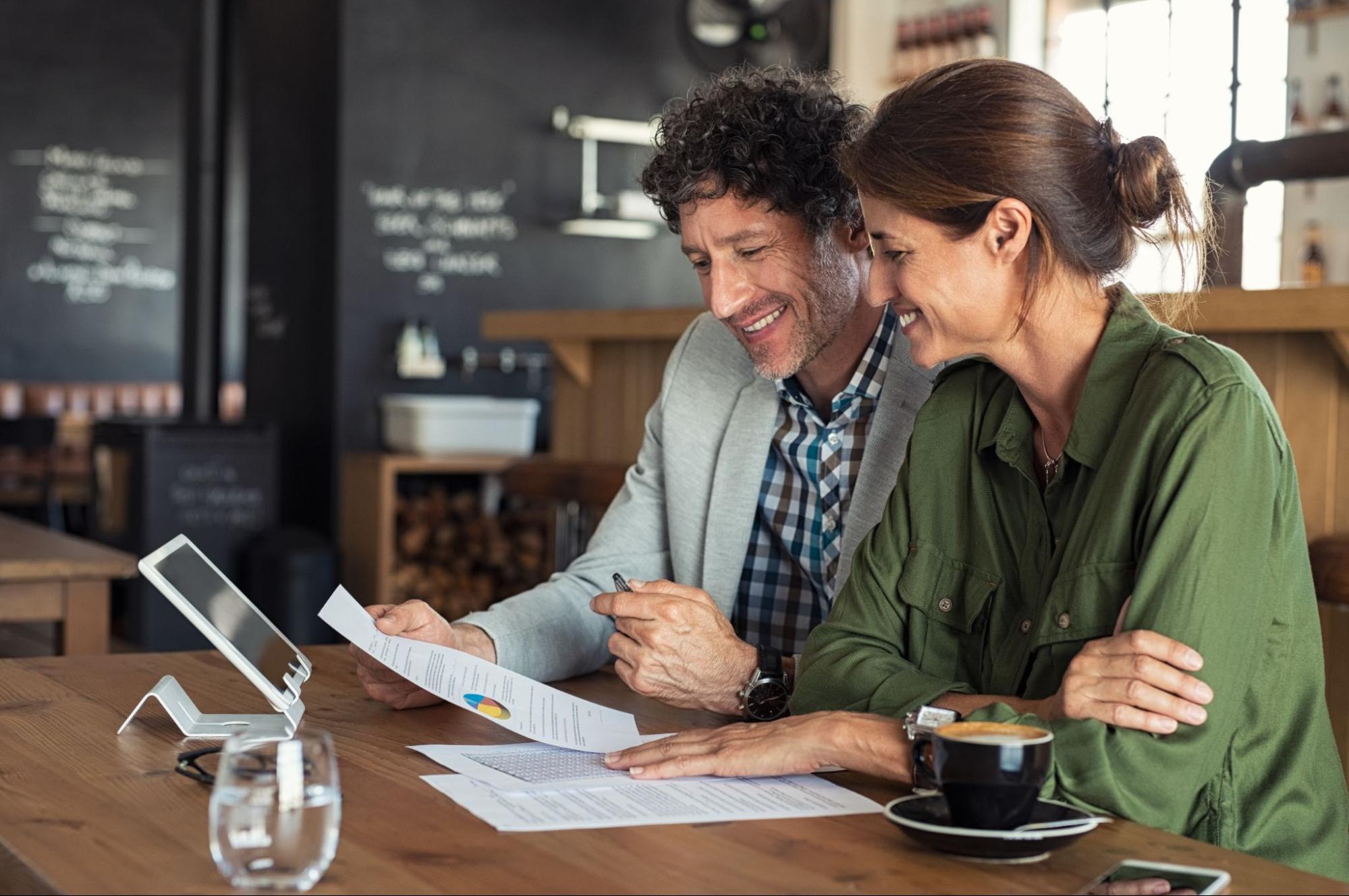 Two people taking a look a their financial reports