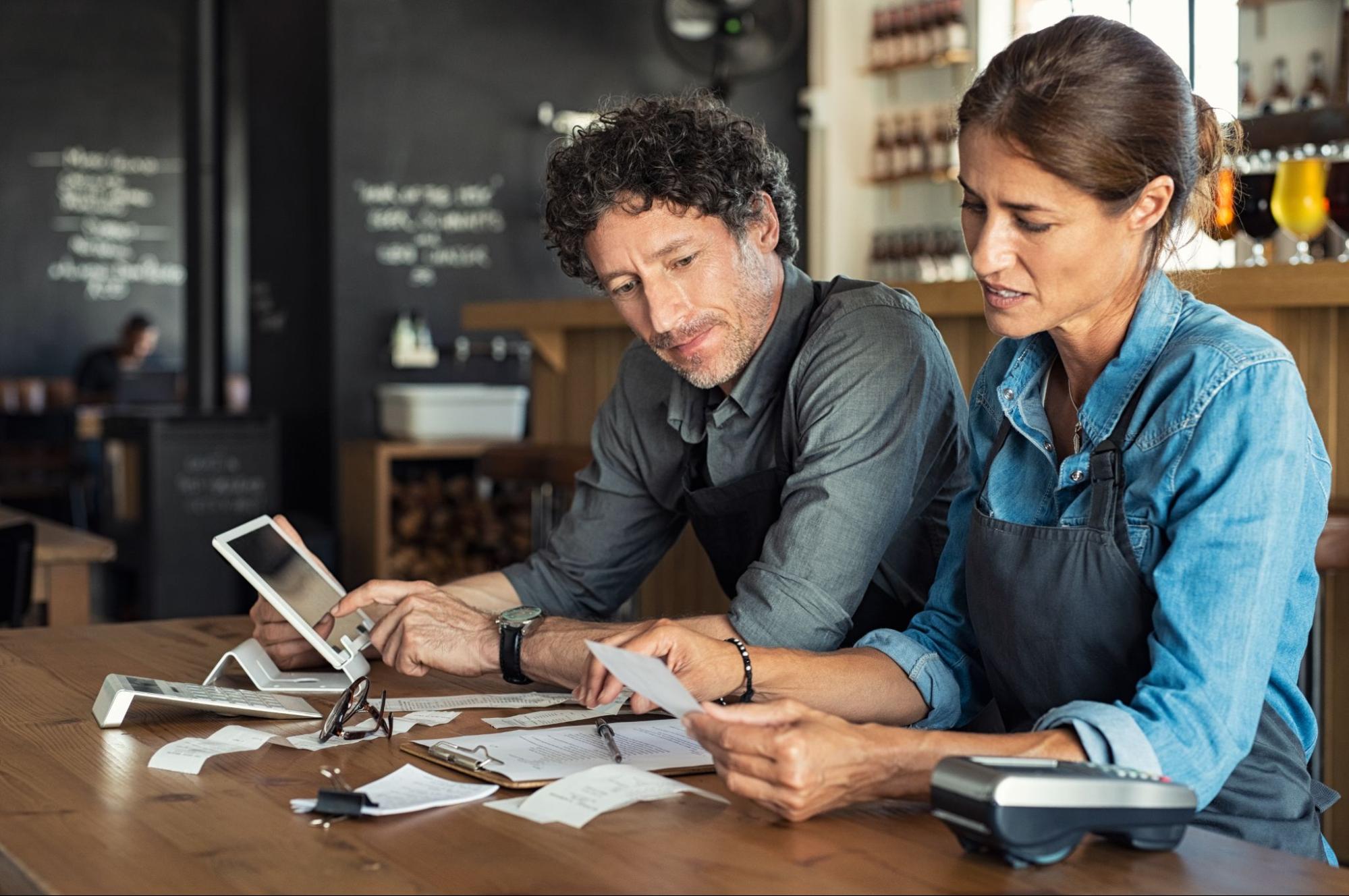 Two people looking at their financial reports