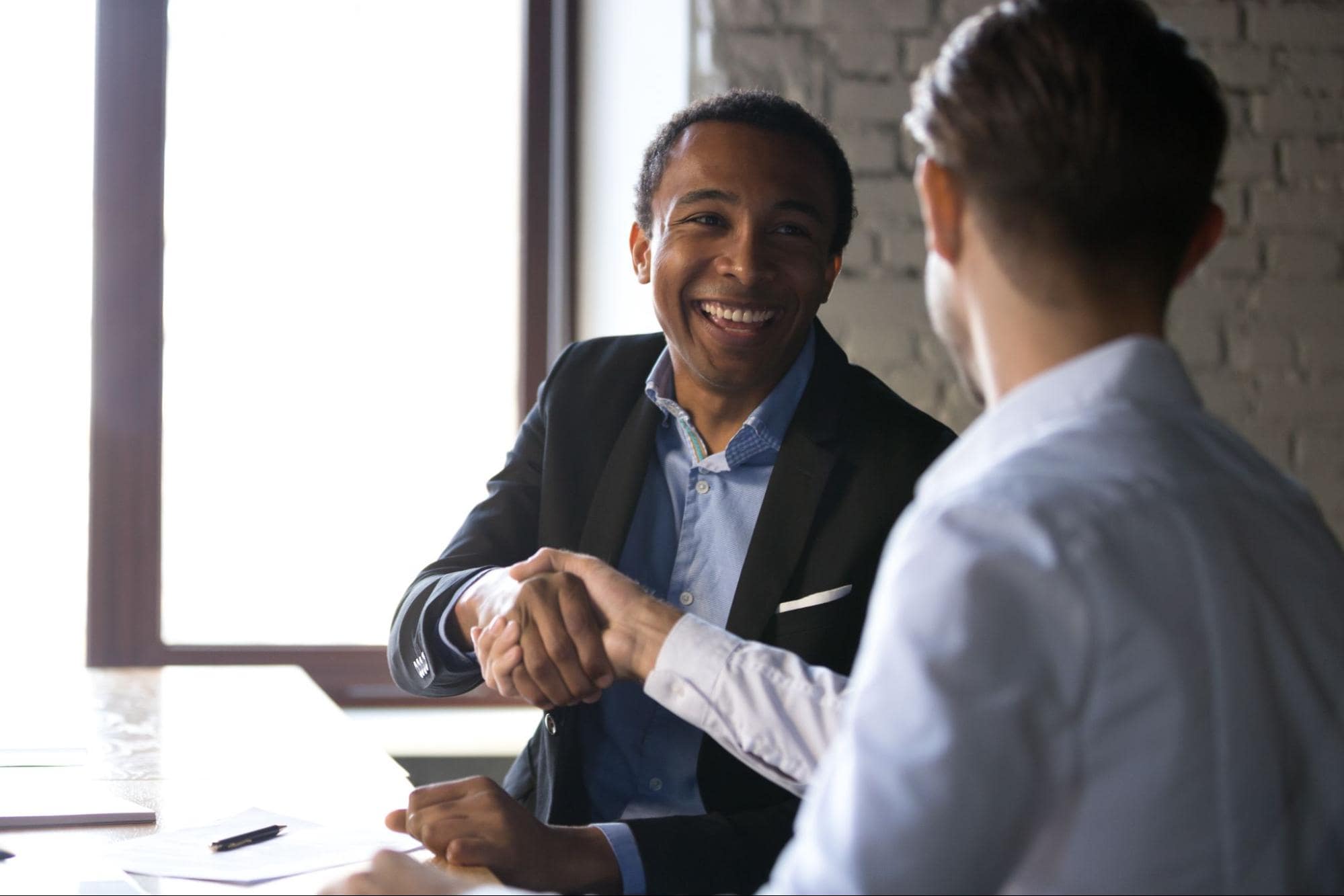 Seller and buyer shaking hands on deal