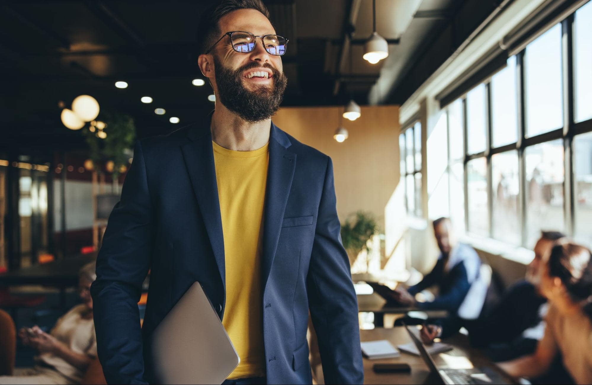 Man smiling and walking through office