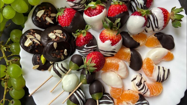 Plate of chocolate-dipped strawberries, grapes, and oranges - a delightful mix of flavors and textures.