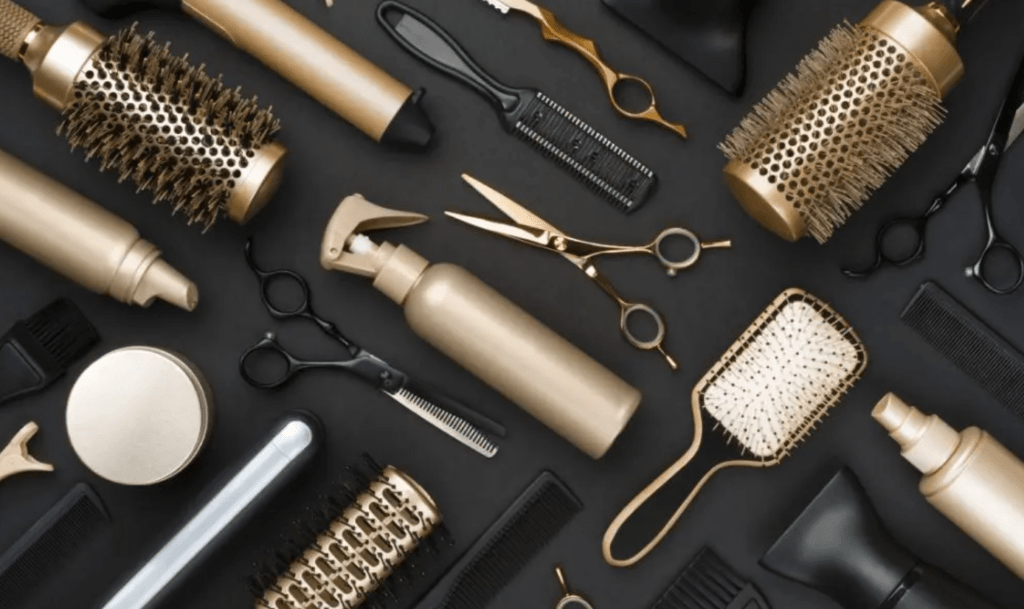 comb brush scissor dryer gold and black background