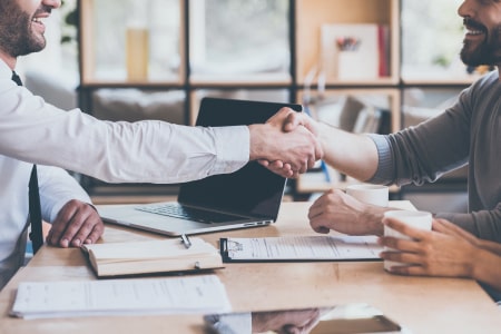 Agent and Client shaking hands after signing contract